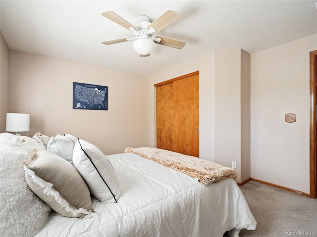 carpeted bedroom featuring a closet and ceiling fan