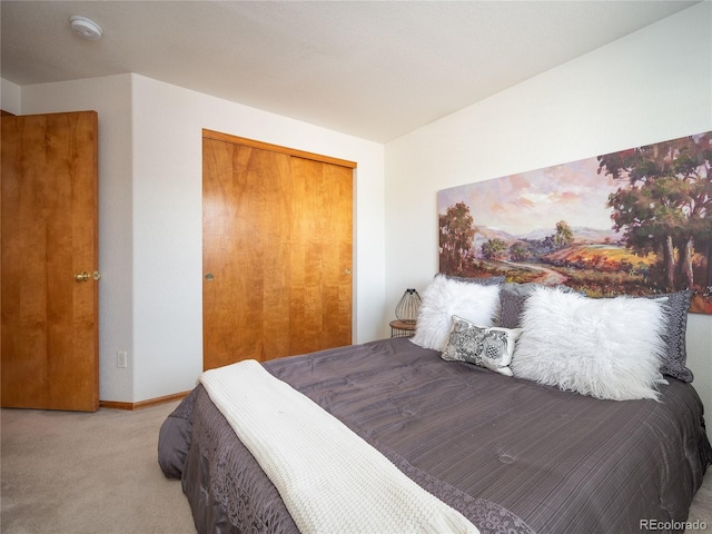 bedroom featuring light carpet and a closet