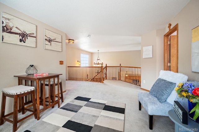 living area featuring light carpet and a notable chandelier