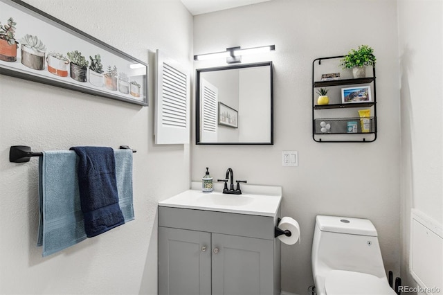 bathroom with toilet and vanity