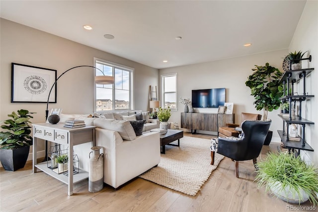 living room with baseboards, wood finished floors, and recessed lighting