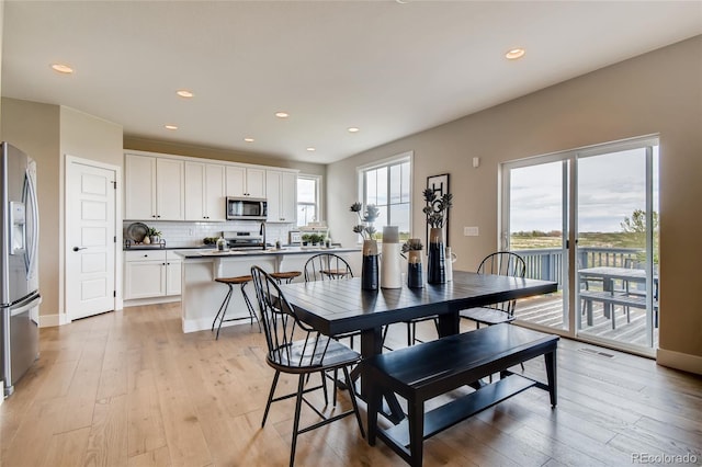 dining space with light wood-style floors, baseboards, visible vents, and recessed lighting