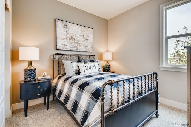 bedroom featuring carpet and baseboards