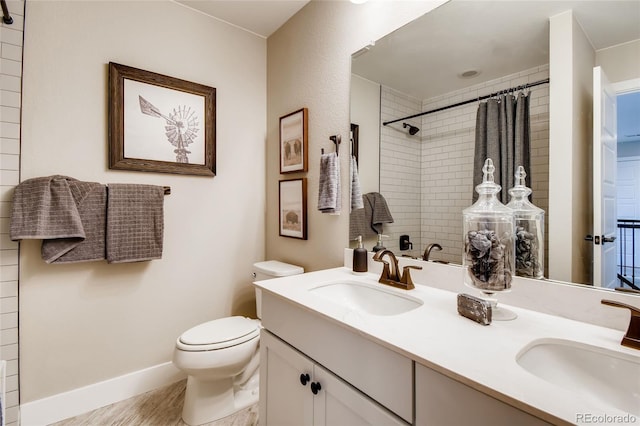 bathroom featuring toilet, double vanity, a sink, and a shower with shower curtain