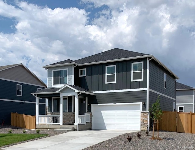 view of front of home with covered porch and a garage