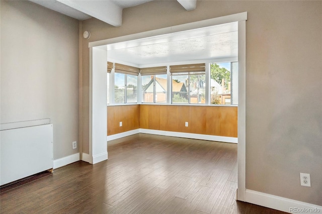 1255 N Ogden St Unit 305, Denver, CO 80218 - spare room featuring baseboards and wood finished floors