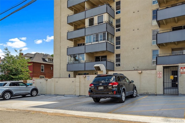 1255 N Ogden St Unit 305, Denver, CO 80218 - view of apartment building / complex featuring uncovered parking