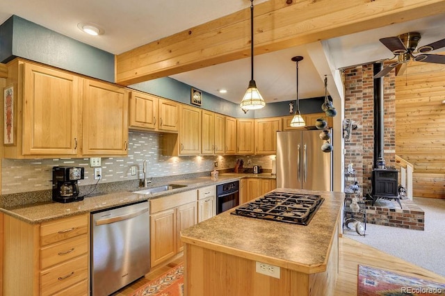 kitchen with a center island, light brown cabinetry, decorative backsplash, black appliances, and a sink