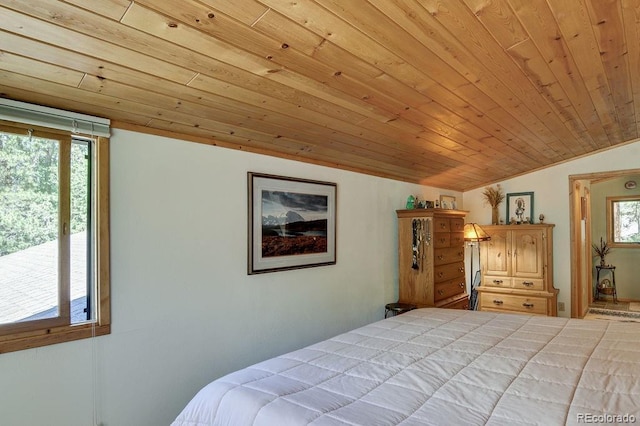 bedroom featuring vaulted ceiling, multiple windows, and wood ceiling