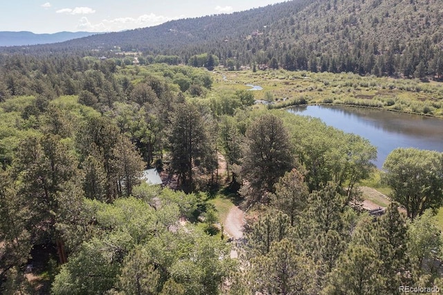 aerial view with a forest view and a water and mountain view