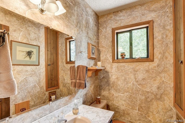 bathroom with vanity and a textured ceiling