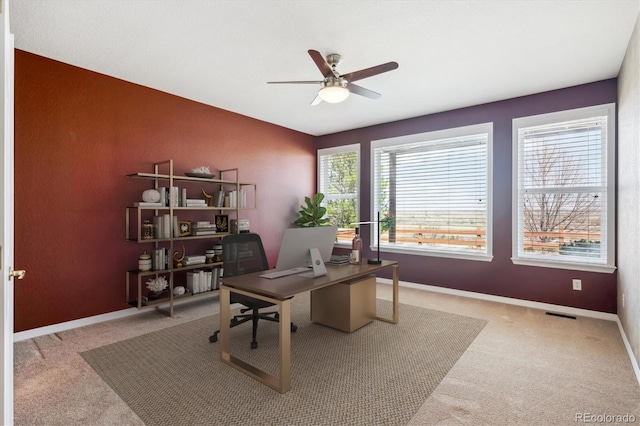 carpeted office featuring a ceiling fan, baseboards, and visible vents