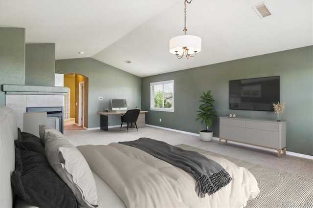 bedroom with a notable chandelier, visible vents, vaulted ceiling, arched walkways, and light colored carpet