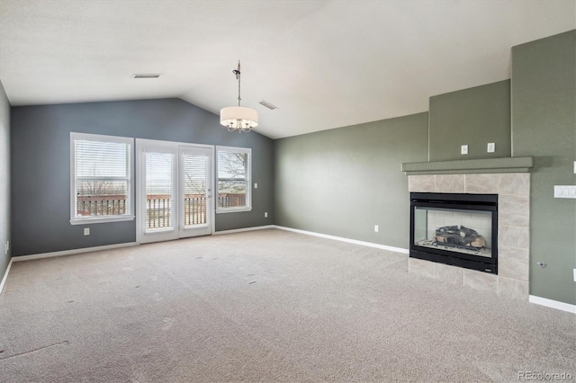 unfurnished living room with carpet flooring, visible vents, baseboards, and lofted ceiling