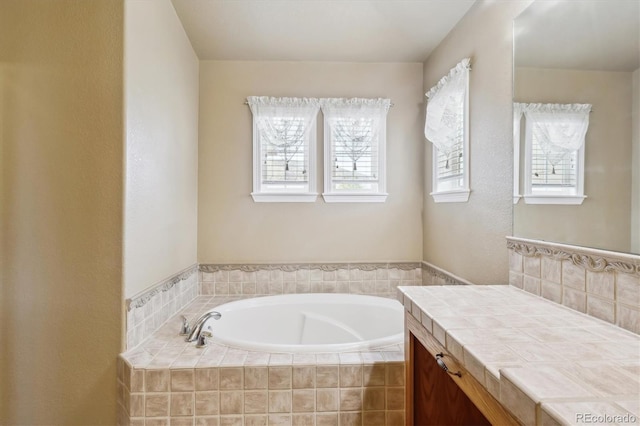 full bathroom with a garden tub and vanity