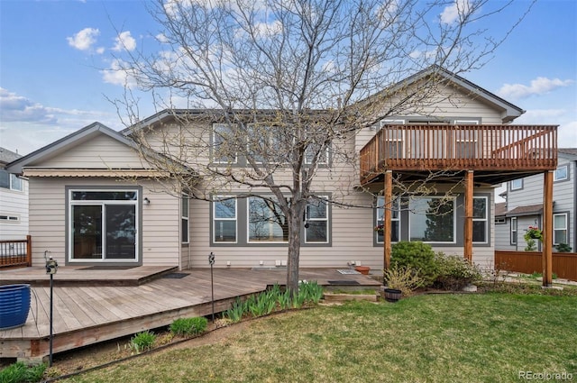 back of house featuring a yard and a wooden deck