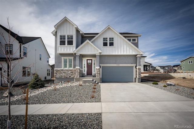 craftsman inspired home with board and batten siding, concrete driveway, stucco siding, stone siding, and an attached garage