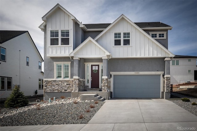 craftsman-style house with a garage, stone siding, board and batten siding, and driveway