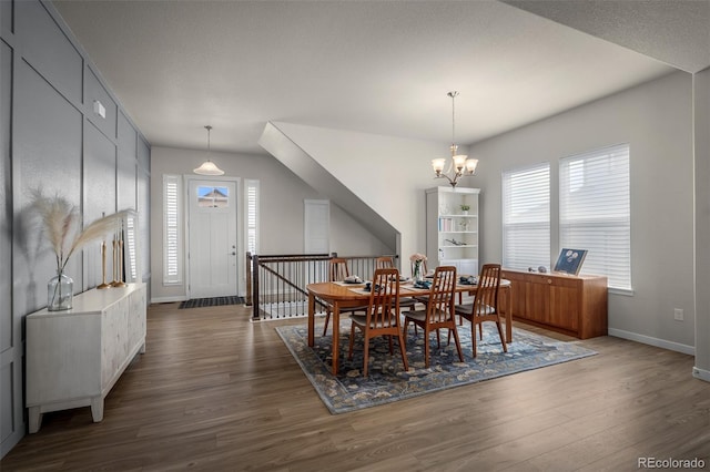 dining room with a notable chandelier, dark wood-style floors, and baseboards