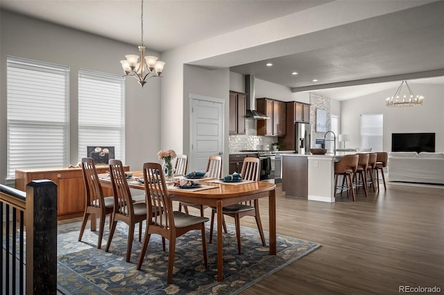 dining area featuring an inviting chandelier, recessed lighting, and dark wood-style floors