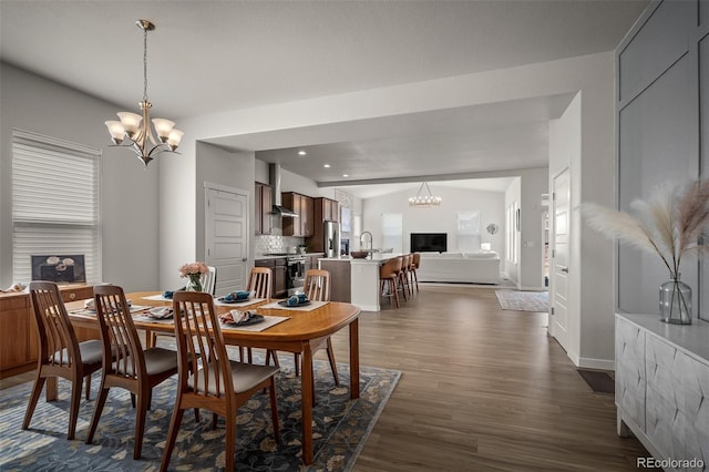 dining room with recessed lighting, lofted ceiling, a notable chandelier, and dark wood-style floors