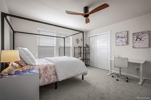 bedroom with a ceiling fan, carpet, a closet, and baseboards