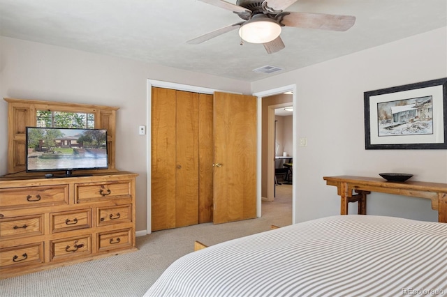 bedroom featuring light carpet, a closet, and ceiling fan