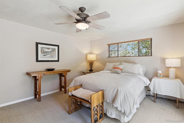 bedroom featuring light colored carpet, baseboards, and ceiling fan