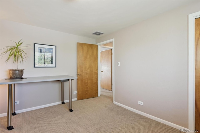 office with light carpet and baseboards