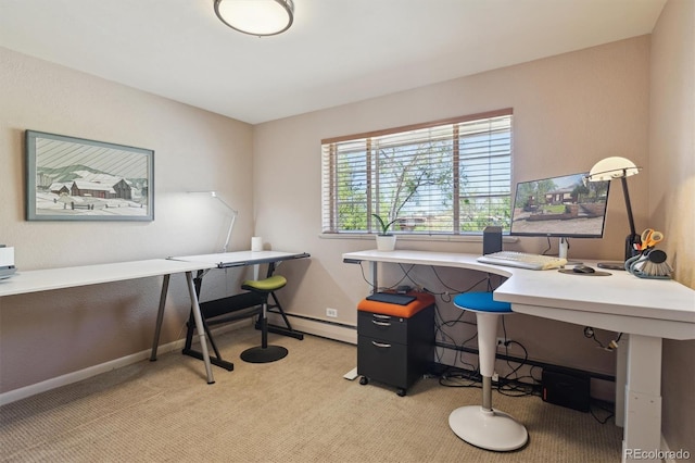 office space with a baseboard heating unit, light carpet, and baseboards