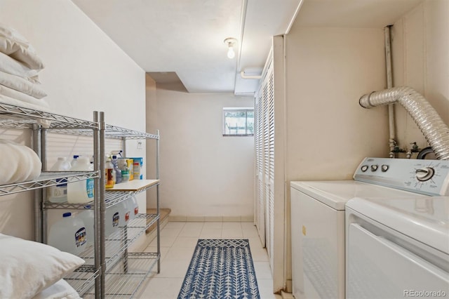 laundry room with washer and clothes dryer and light tile patterned flooring