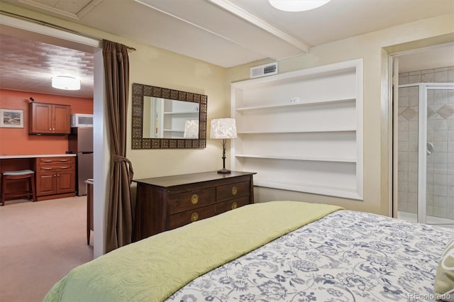 bedroom featuring carpet flooring, freestanding refrigerator, and an office area