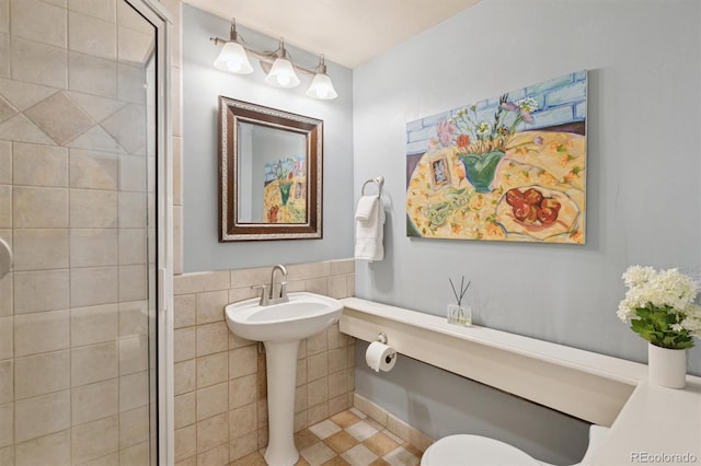 full bathroom featuring a shower stall, tile patterned flooring, and toilet