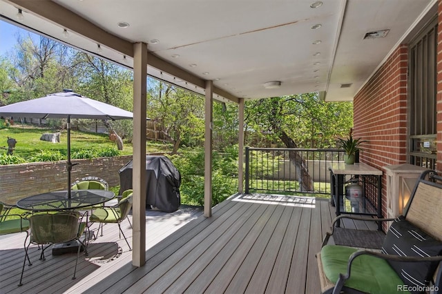 deck featuring grilling area and outdoor dining area