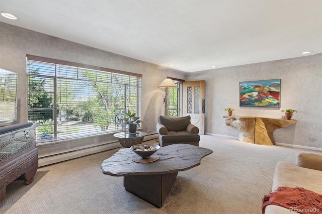 carpeted living area with a baseboard heating unit and recessed lighting