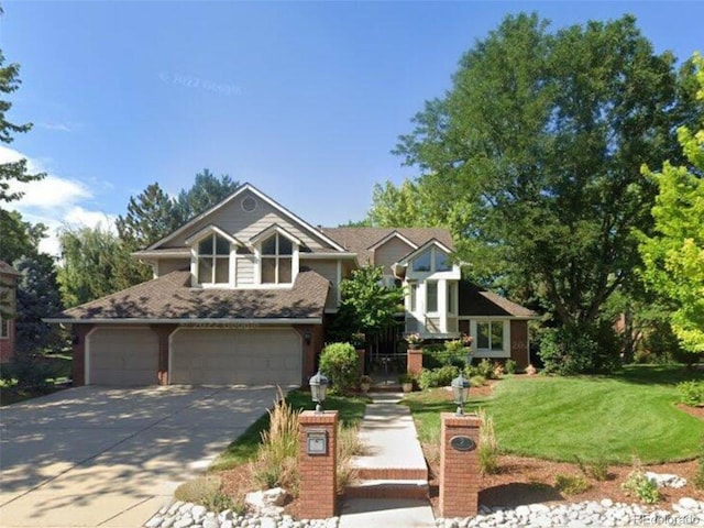 view of front facade with concrete driveway, a front lawn, and an attached garage