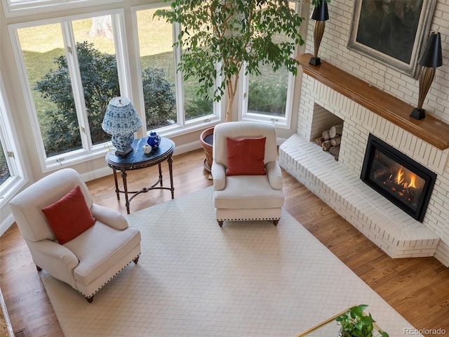 sunroom featuring a brick fireplace