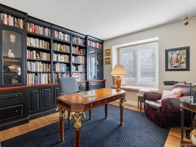 home office with a textured ceiling and wood finished floors