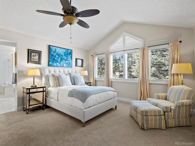 bedroom with vaulted ceiling, a textured ceiling, and light colored carpet