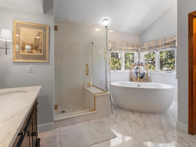 bathroom featuring lofted ceiling, vanity, a freestanding bath, marble finish floor, and a stall shower