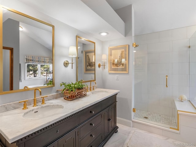 bathroom with marble finish floor, a sink, a shower stall, and double vanity