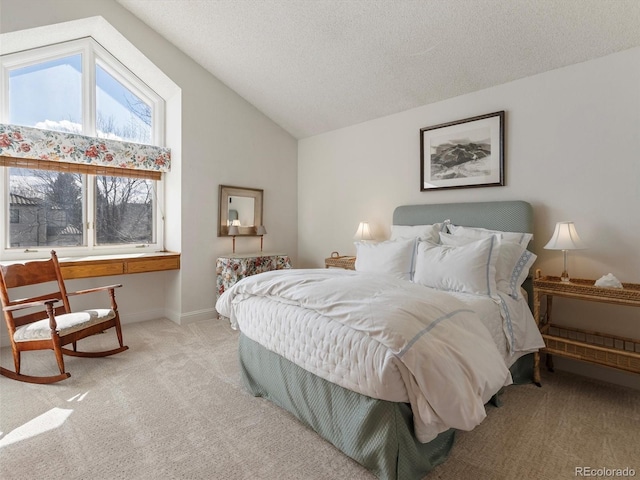 bedroom with lofted ceiling, a textured ceiling, light carpet, and baseboards