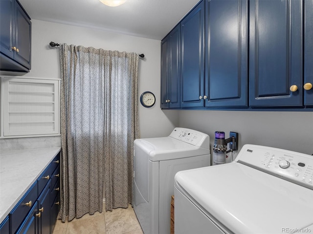 washroom featuring washing machine and dryer and cabinet space