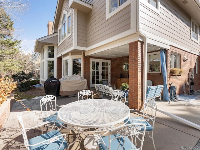 view of patio / terrace with french doors, outdoor dining space, and area for grilling