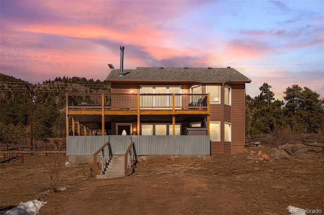 rear view of property featuring a deck