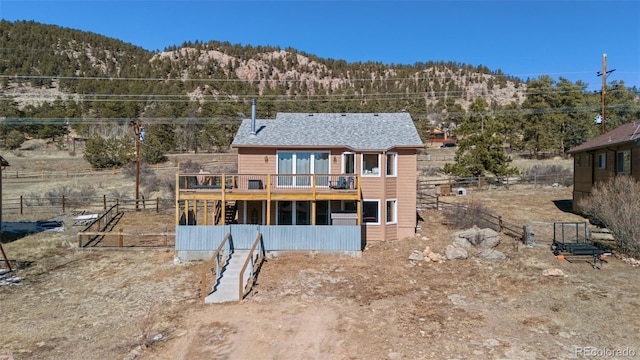 rear view of property with fence