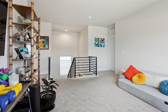 interior space featuring recessed lighting, visible vents, an upstairs landing, carpet floors, and baseboards