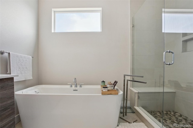bathroom featuring a freestanding bath and a stall shower