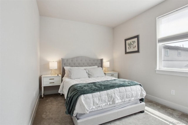 carpeted bedroom featuring baseboards and multiple windows
