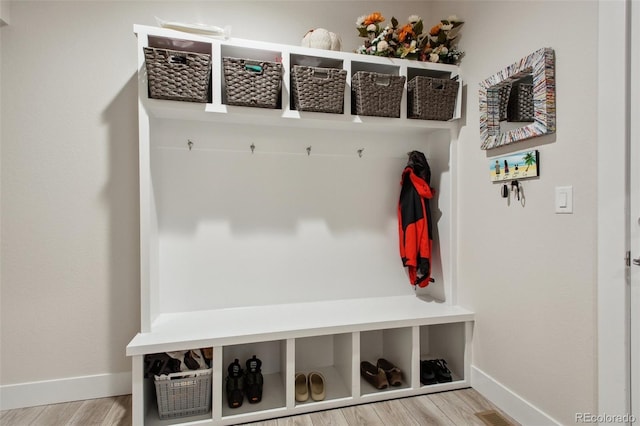 mudroom featuring wood finished floors, visible vents, and baseboards